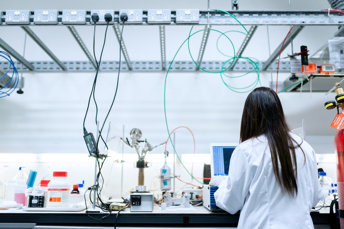 Back of A Scientist On A Laptop In A Lab Setting