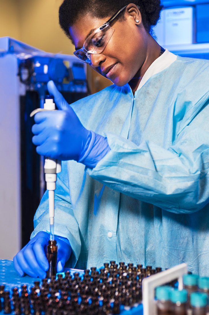 Scientest Using A Syringe Into A Dram Amber Glass Vial