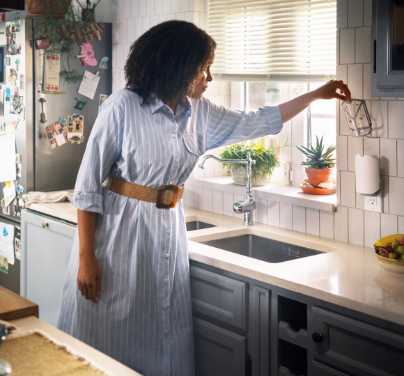 Woman in Kitchen Removing Zevo Trap Cartridge From Trap Body