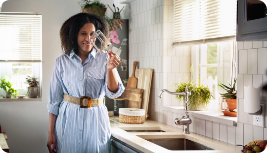 Woman Inspecting a Zevo Trap Cartridge In A Kitchen